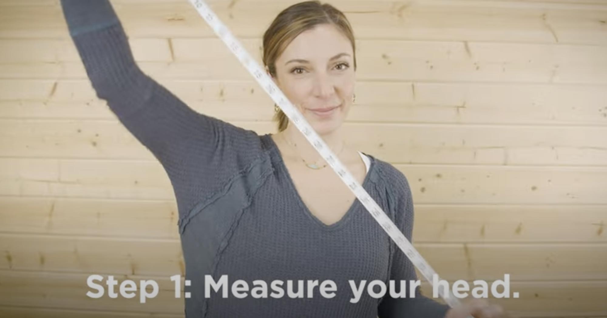 A photo demonstrating the first step to finding your hat size, which is measuring your head.