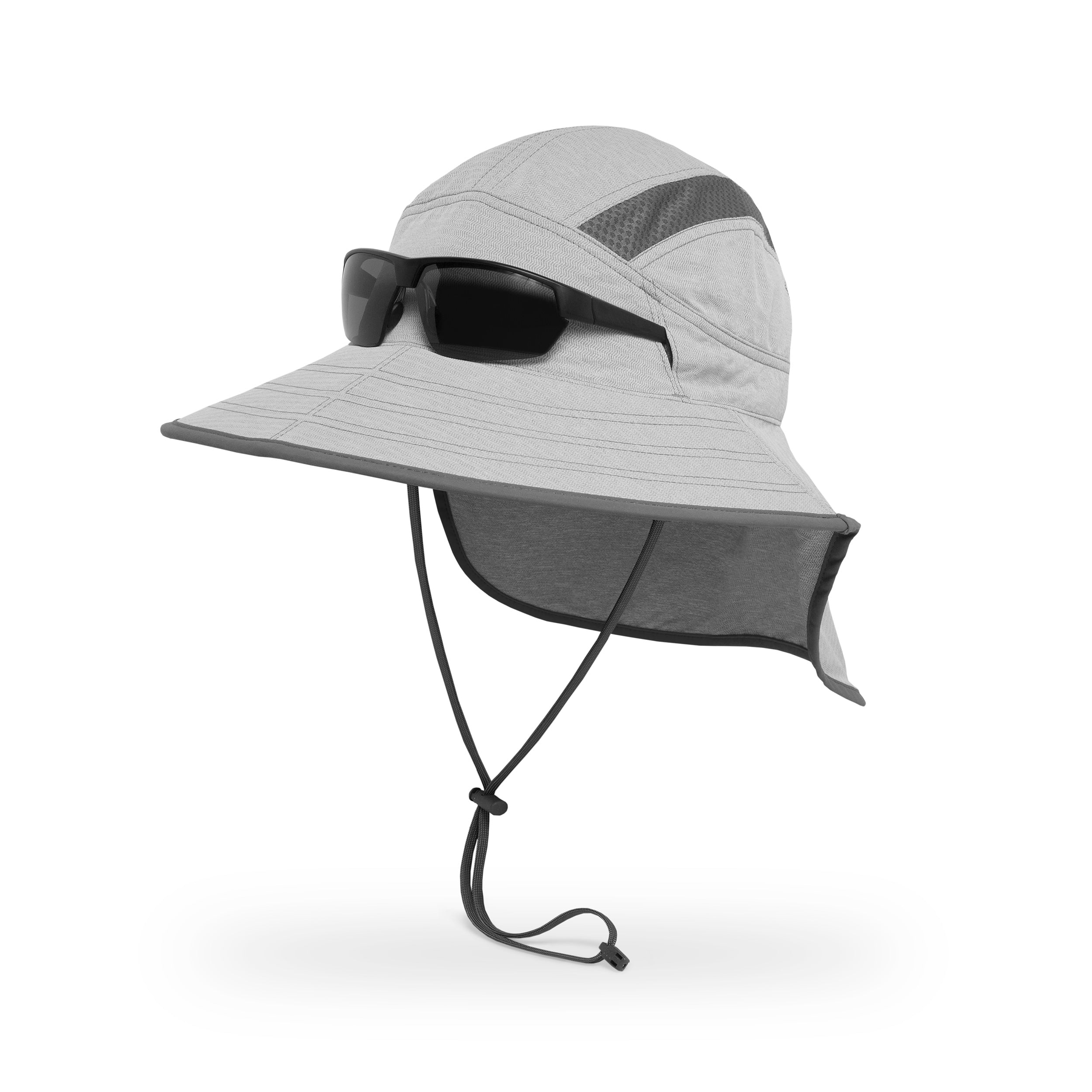 A studio photo of a Sunday Afternoons Ultra Adventure Hat, showing the sunglass lock with sunglasses in the slots on the sides of the hat.